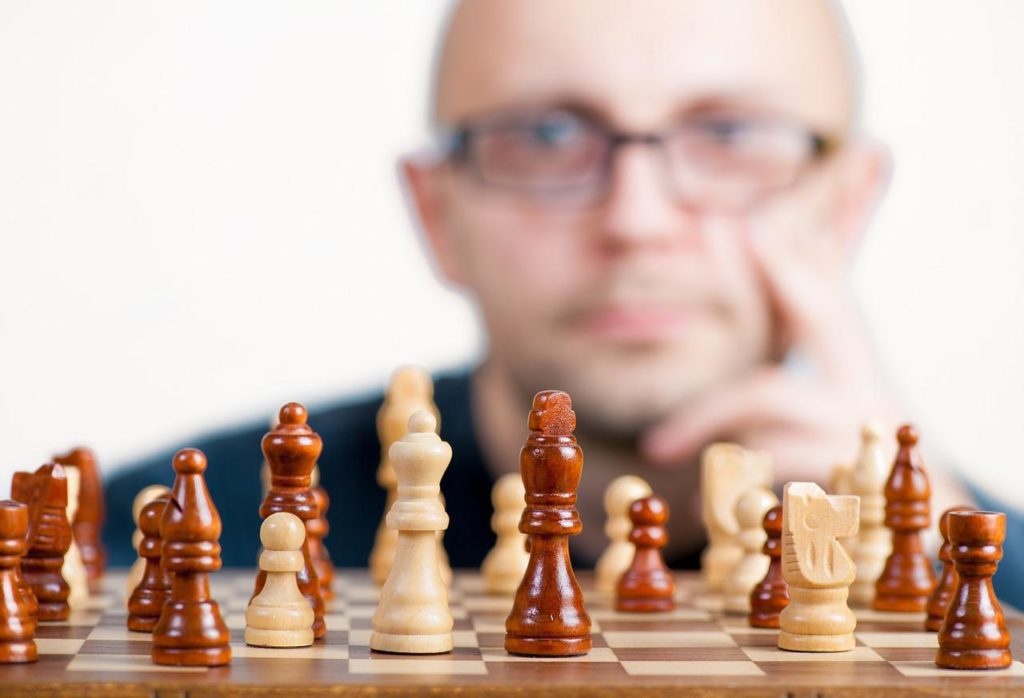 man focused on the competition playing chess